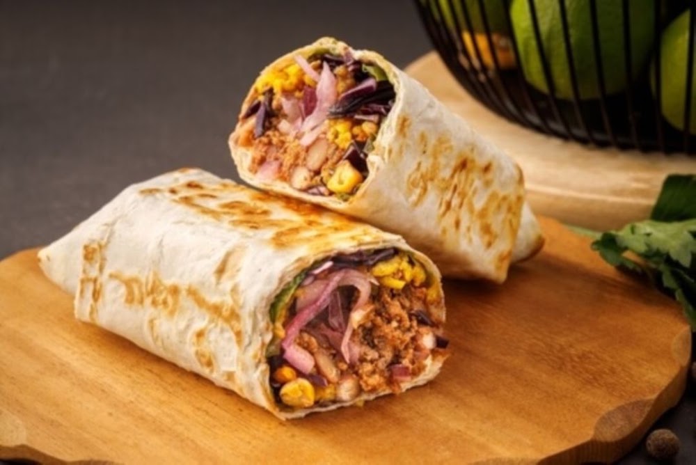 Grilled chicken burrito cut in half