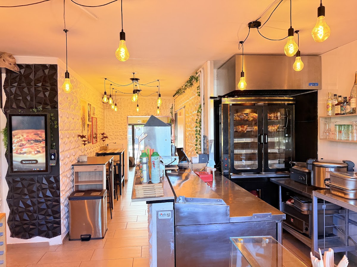 Buena Vista interior with rotisserie oven and warm pendant lights